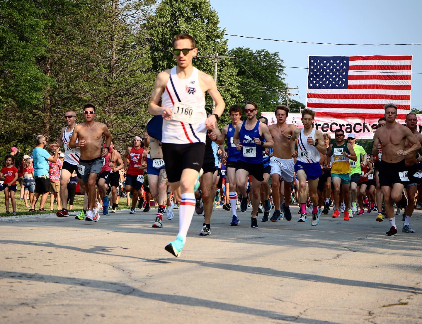 picture of a runner with the American flag behind him.