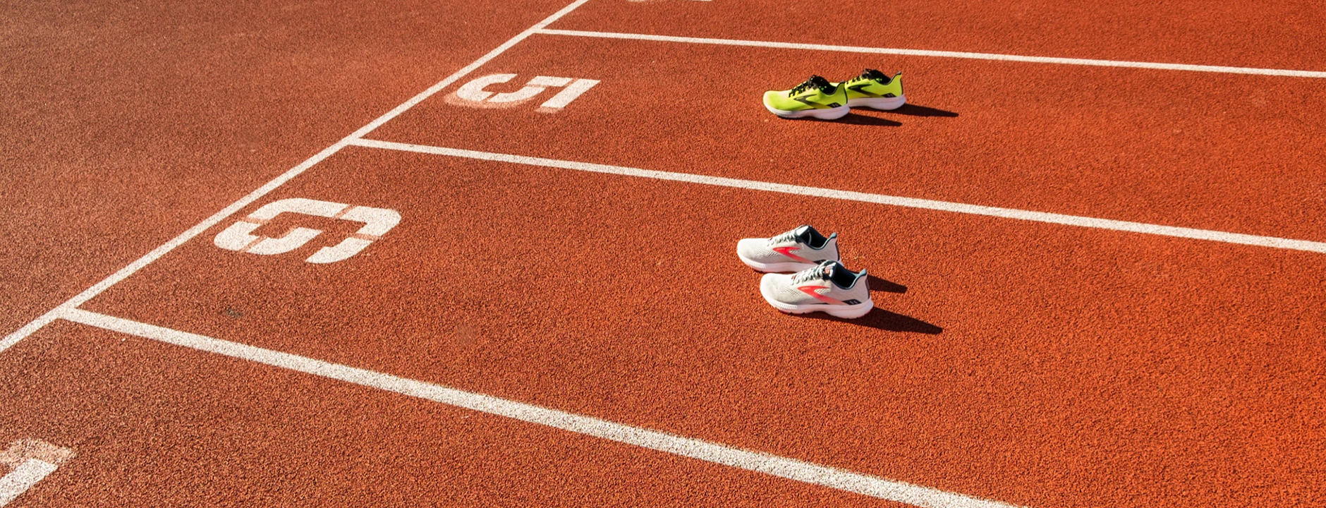 picture of shoes on a red track.