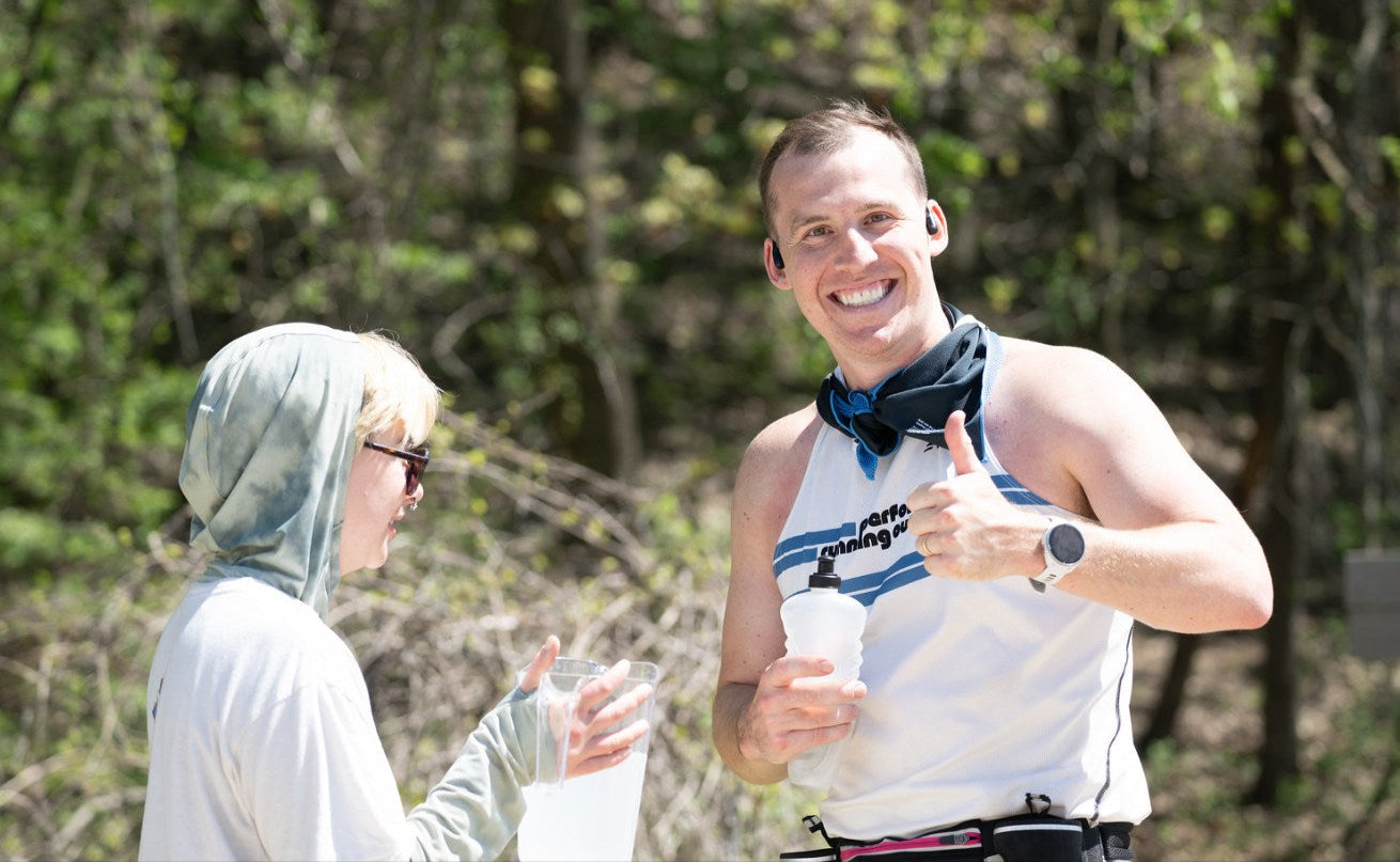 Two people outdoors with one giving a thumbs-up gesture