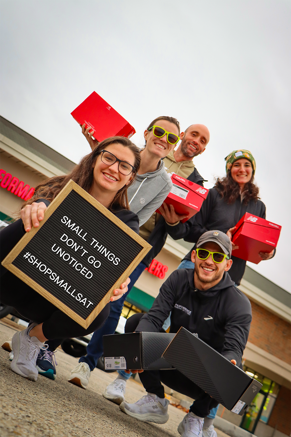 Picture of the Brookfield Pro team holding shoes and a sign saying shop small