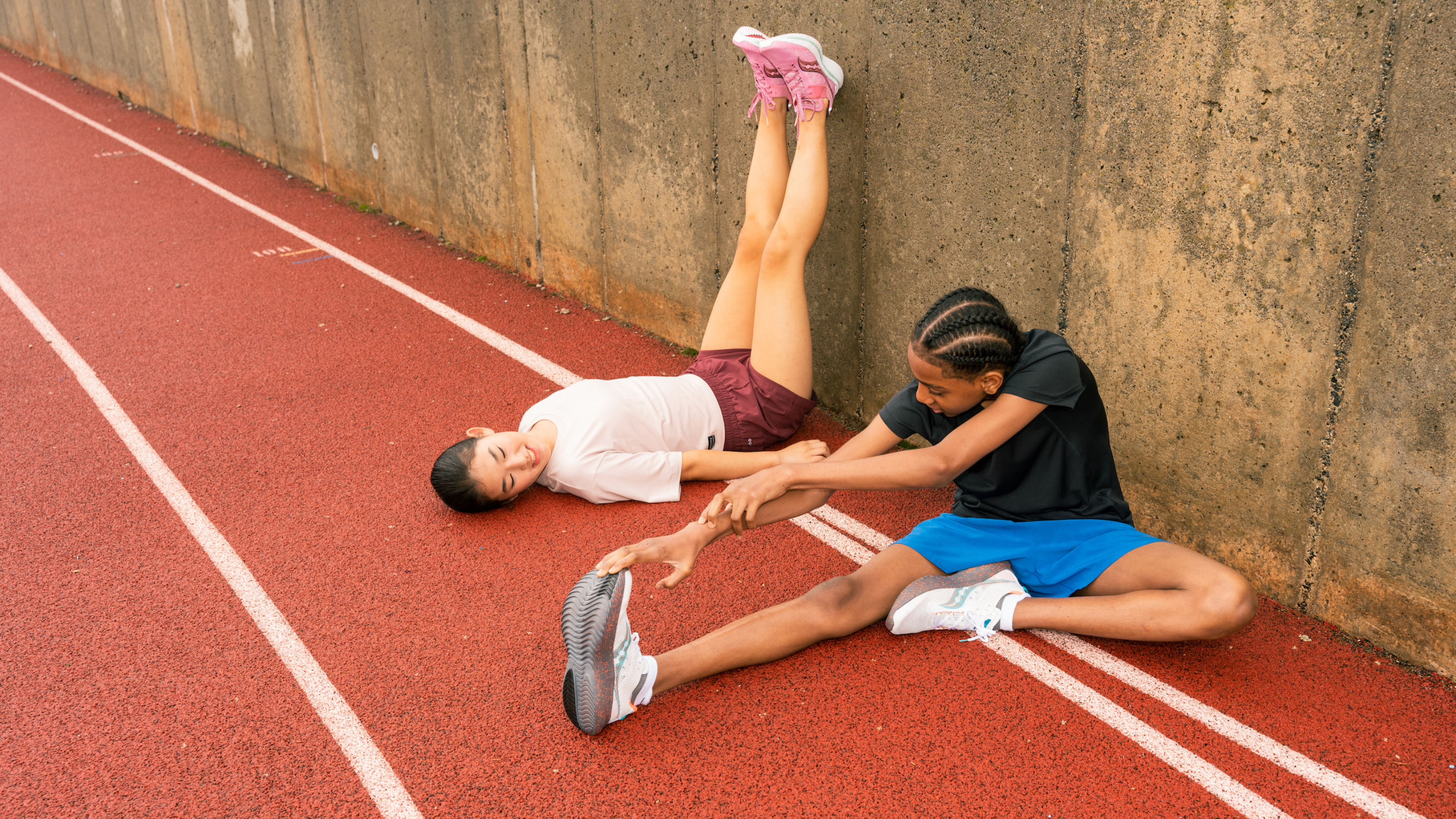 picture of two athletes stretching.